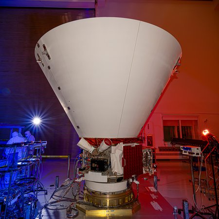 SPHEREx in a lab with colored lights around it.