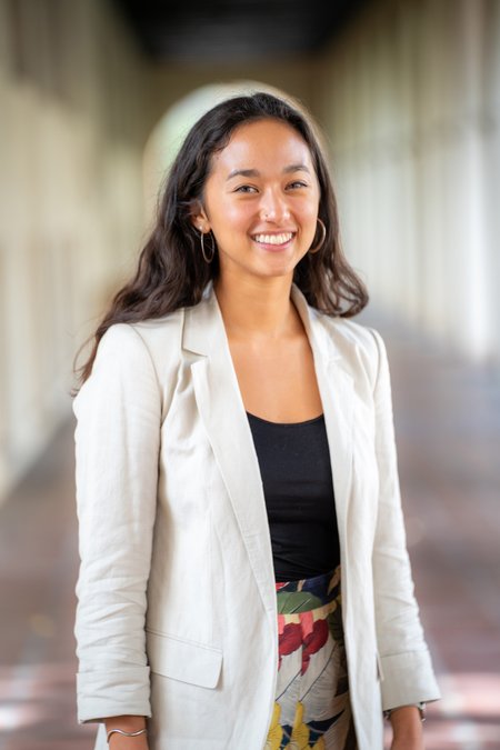 A headshot of a woman in a blazer