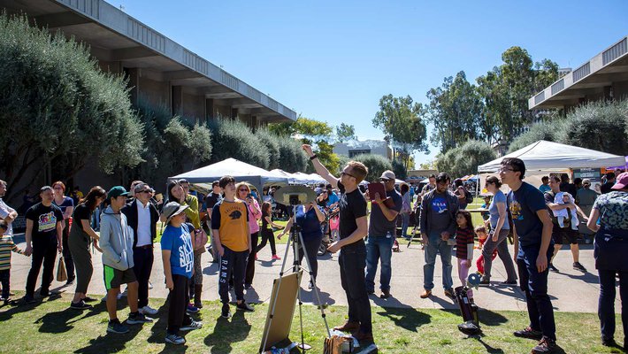 Postdoctoral scholar Cameron Hummels leads an astronomy demonstration while visitors to the second annual Science for March event watch.