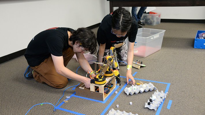 At the 2016 Science Olympiad event at Caltech, participants from Canyon Crest Academy set up a robotic arm.