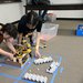 At the 2016 Science Olympiad event at Caltech, participants from Canyon Crest Academy set up a robotic arm.
