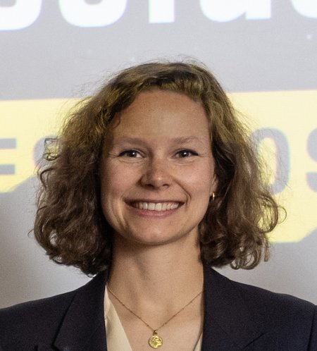 A person smiles for a photo