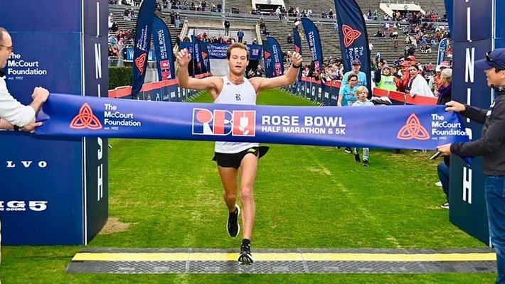 Astrophysics graduate student Adolfo Carvalho crossing the finish line for the Rose Bowl Half Marathon