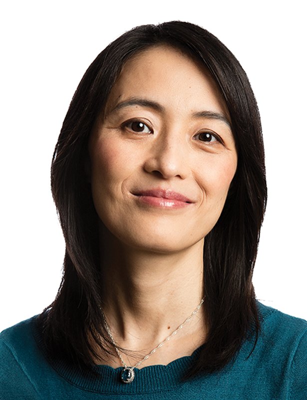 A portrait of Shu-ou Shan wearing a teal sweater and a silver necklace.