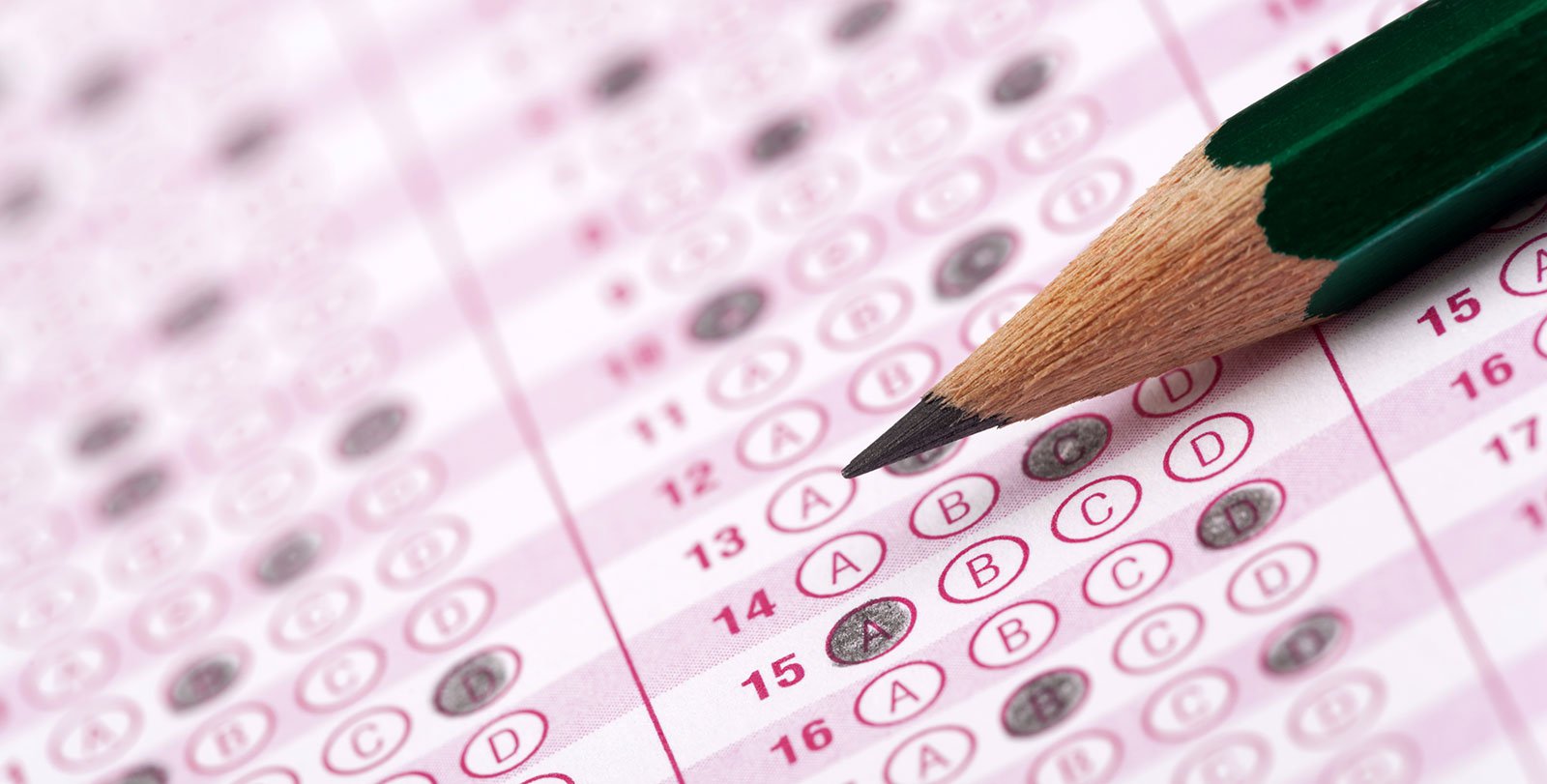Scantron sheet with filled-in answer bubbles and sharpened pencil
