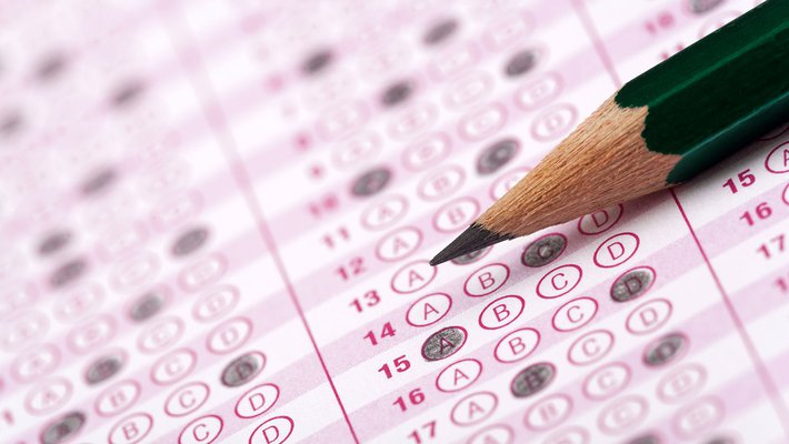 Scantron sheet with filled-in answer bubbles and sharpened pencil