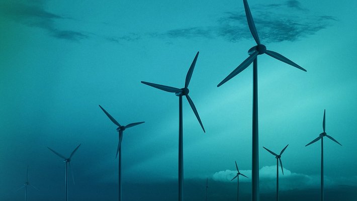 blue filtered image of wind turbines