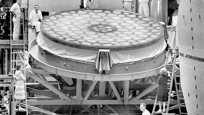 Workers pose with a 200-inch mirror, under construction for Palomar Observatory