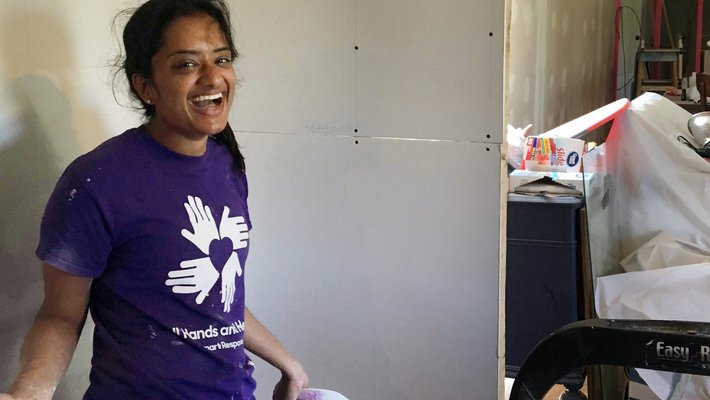 In Texas, junior Meera Krishnamoorthy installs drywall in partnership with All Hands All Hearts, an organization that rebuilds homes after natural disasters.