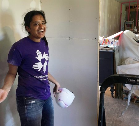 In Texas, junior Meera Krishnamoorthy installs drywall in partnership with All Hands All Hearts, an organization that rebuilds homes after natural disasters.