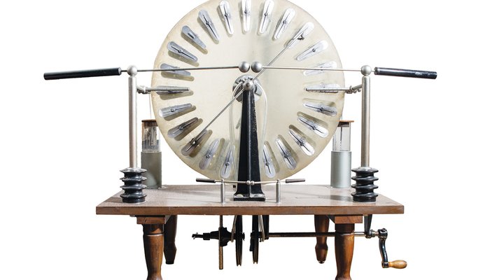 A round contraption sitting upon an old wooden table