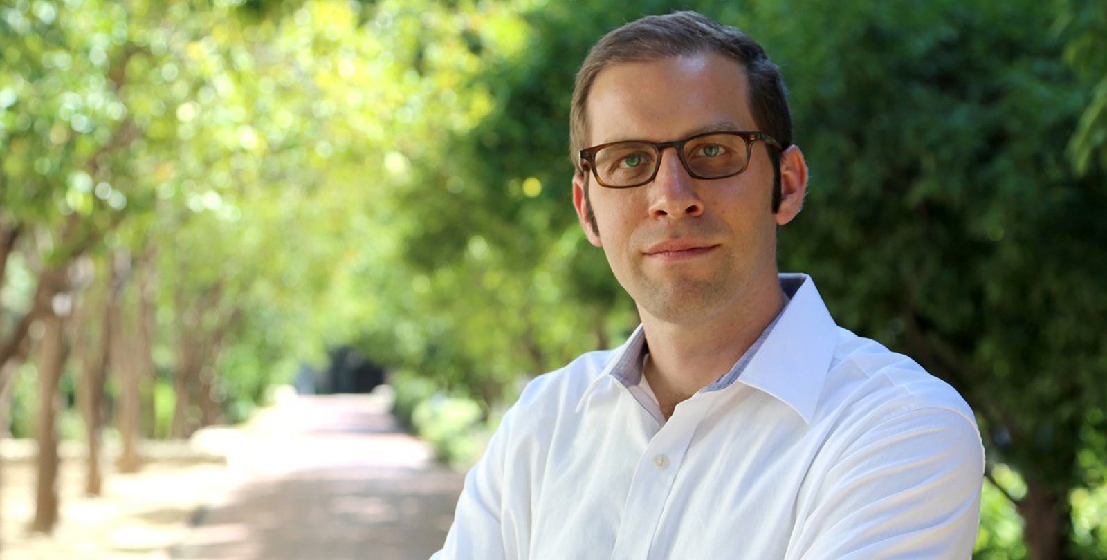 Portrait photo of Joel Tropp. He wears glasses and a white shirt.