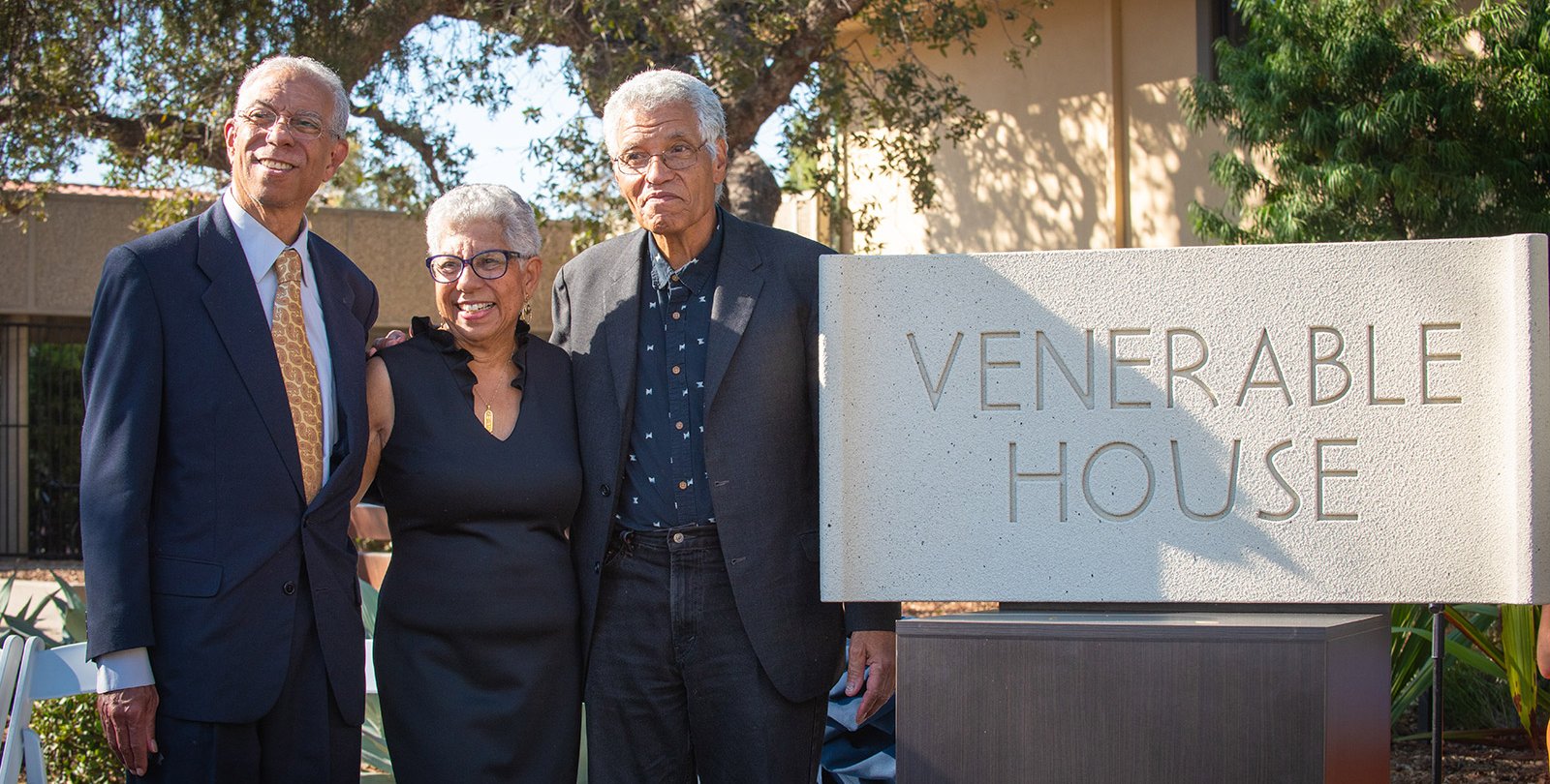 Grant D. Venerable II, Lynda Venerable Ellington, and Lloyd Venerable posed next to the new sign reading "Venerable House"