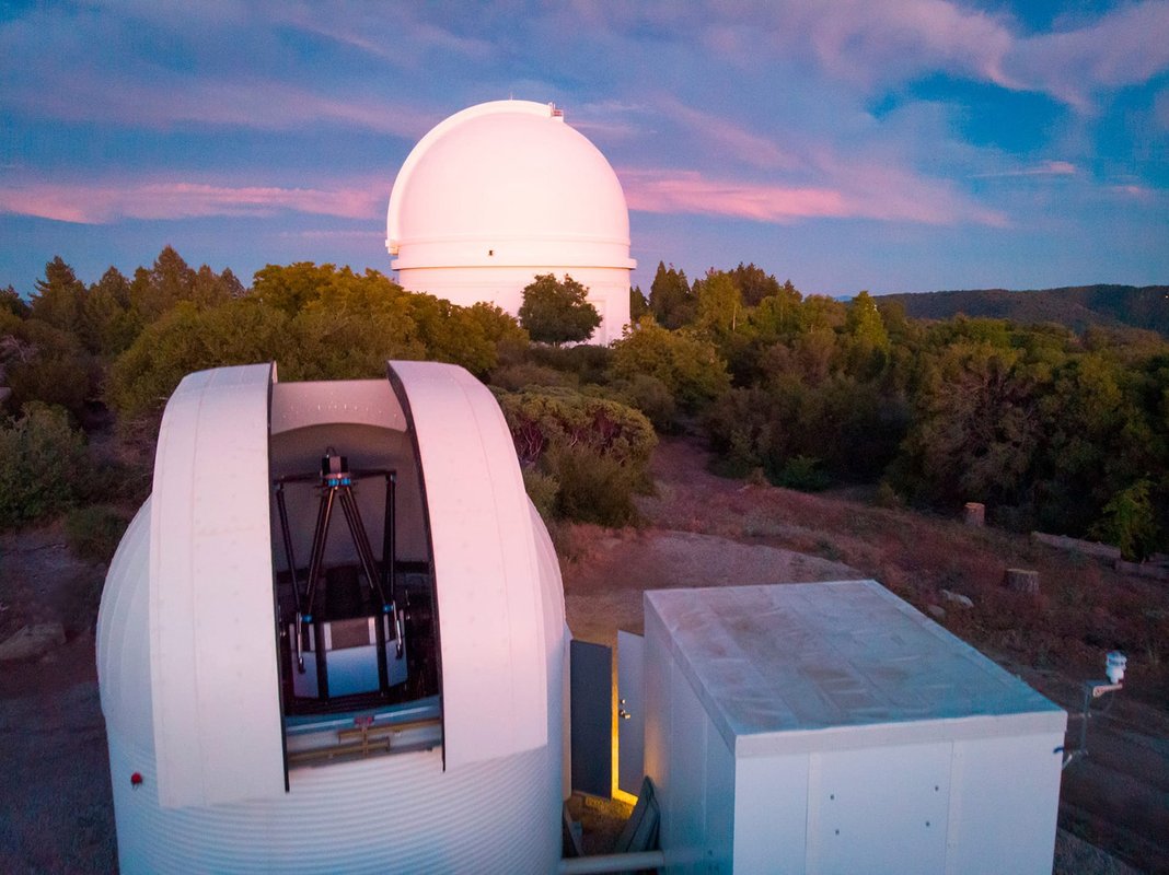 The WINTER telescope at Palomar Observatory, with the 200-inch Hale Telescope dome behind it.