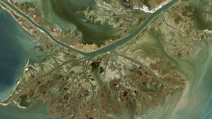 picture of a river delta meeting the sea