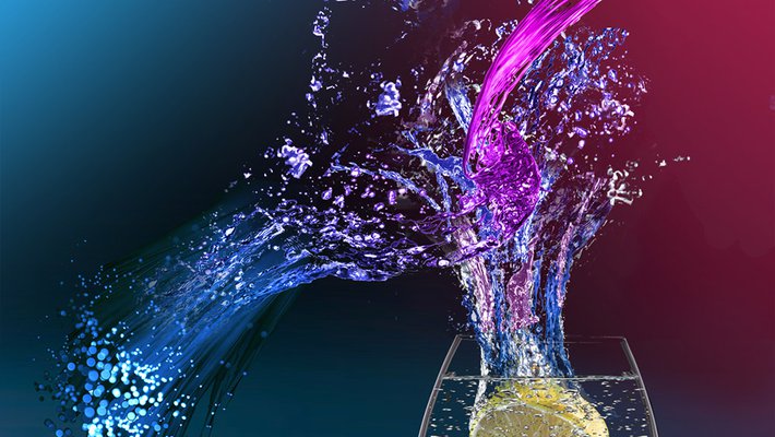 Water pouring into a glass with a lemon in it.