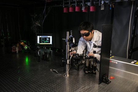 Jiamiao Yang, a postdoctoral scholar in the Caltech Optical Imaging Laboratory, adjusts a photoacoustic microscope.