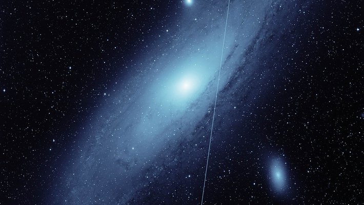 ZTF image of Andromeda galaxy with a Starlink streak through it.