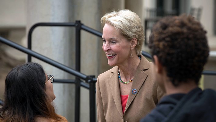 photo of Frances Arnold greeting people at the event