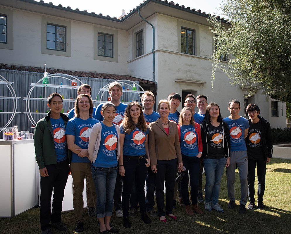 photo of Frances Arnold and members of her research team gathered after the festivities