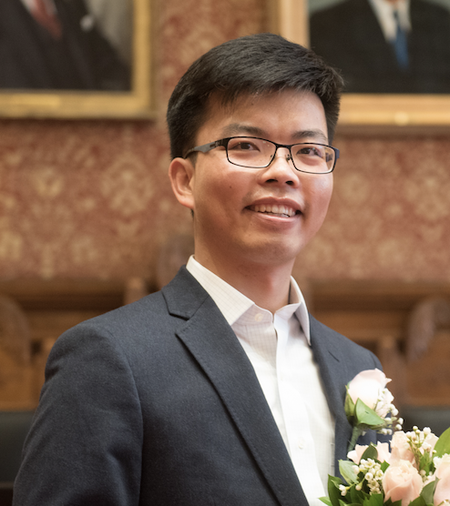 A person with glasses smiles for a photo