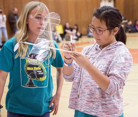Emilia Ellegaard and Amy Wang, from Mesa Verde Middle School, prepare to launch their rubber-band-powered airplane; their goal was to have the airplane stay aloft as long as possible.