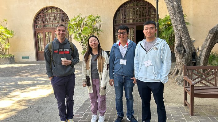 Four students standing together