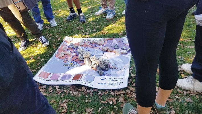 Rocks from the Arroyo Seco laid out on a piece of paper