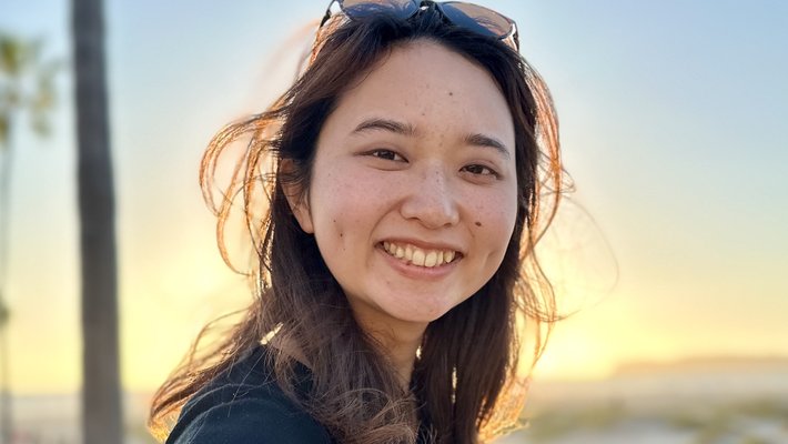 Portrait of Honami Tanaka in front on a sunset.