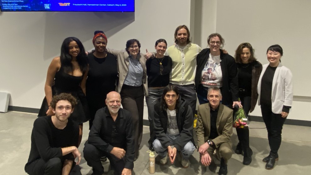 A group of people pose in front of a screen that says "The Null Test"