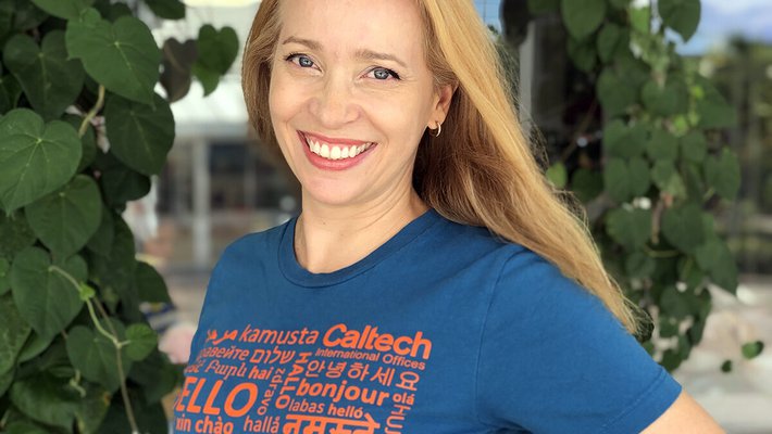 Woman posing in a t-shirt that says "hello" in many languages