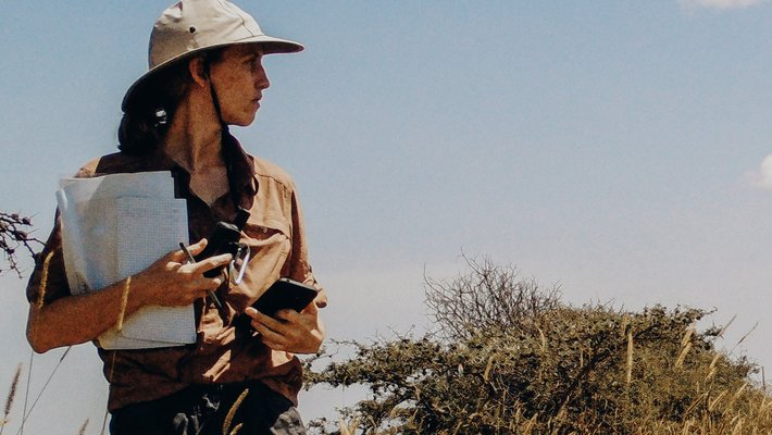 Sara Beery looking out over African plains