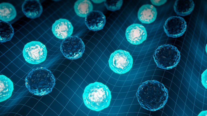 An artist's concept of cells being aligned by ultrasound. Spheres with different appearances line up in troughs and peaks of waves.