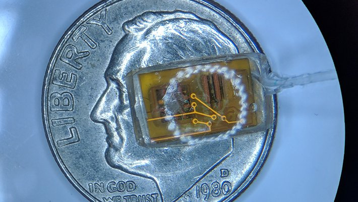 A new pressure-sensing implant for the eye on top of a dime for scale.