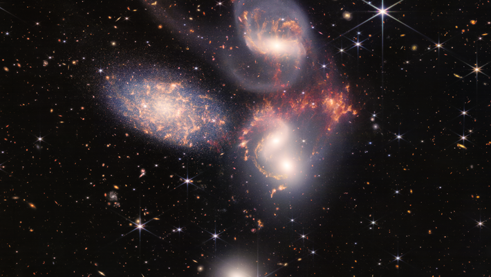 A group of colorful galaxies in space