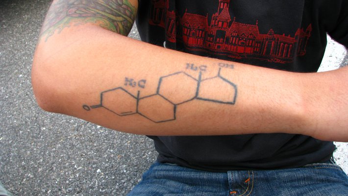 A man's forearm with a tattoo of the testosterone molecule